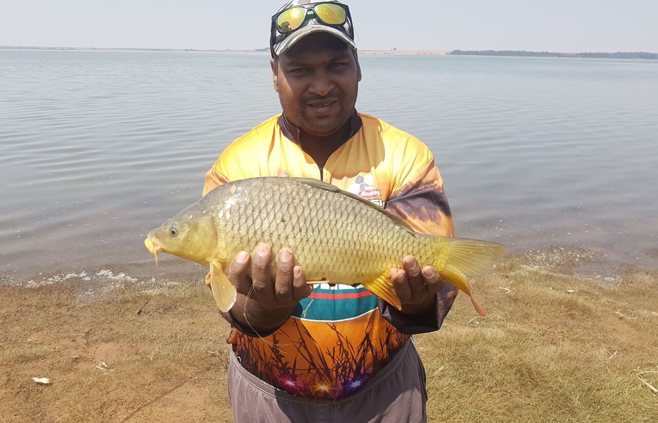 An angler with a golden carp at Vaal Rawdah